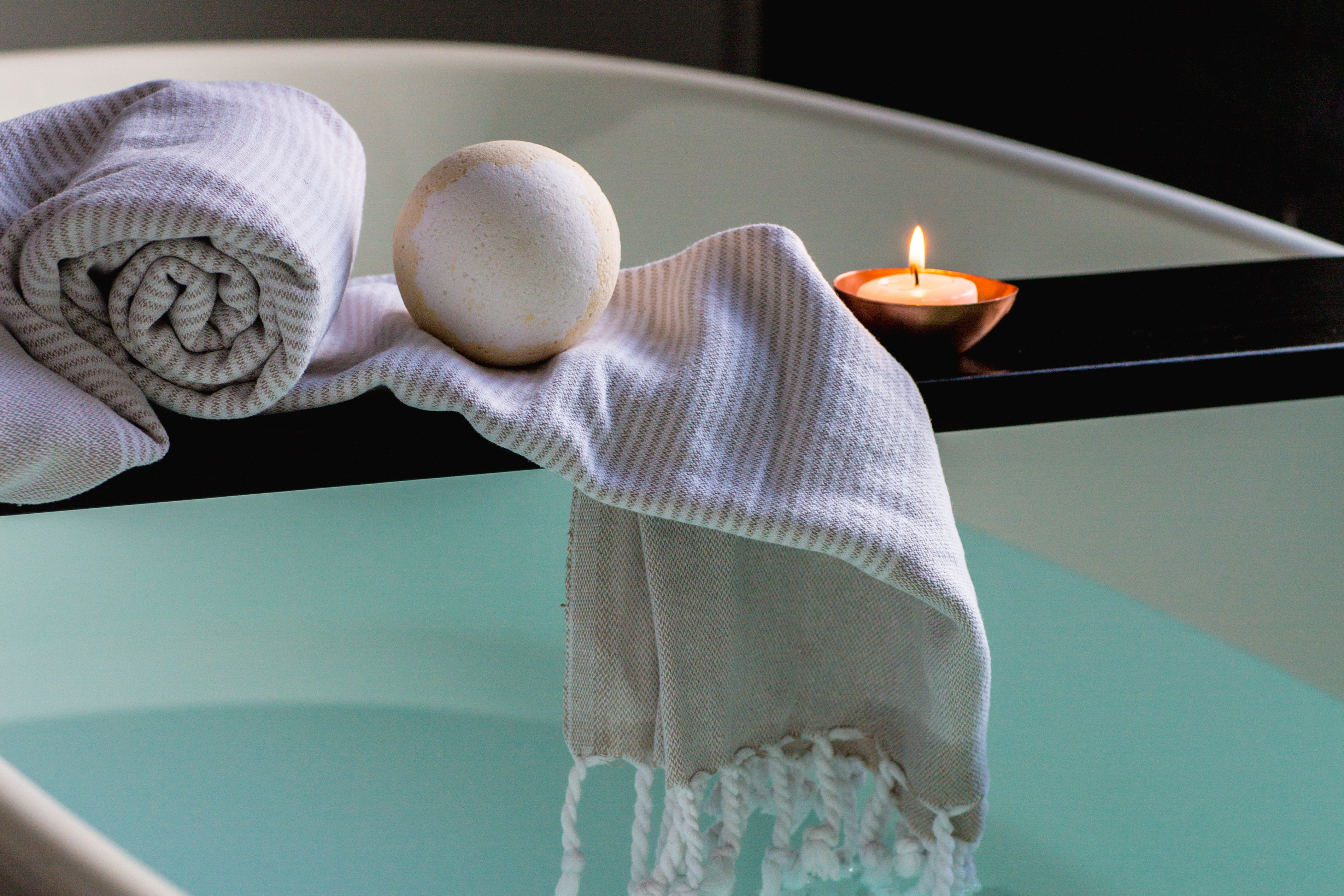 Picture of a bath with candles and a towel.